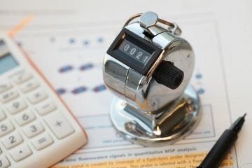 Calculator and office equipment on some paper at SCTbio offices in Prague.