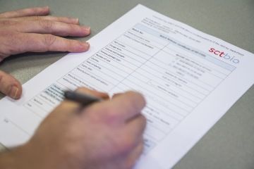 Calculator and office equipment on some paper at SCTbio offices in Prague.